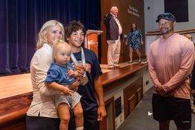 Elin Nordegren, left, poses for a picture with her son, Charlie Woods, to her right, as his father, Tiger Woods smiles during a ceremony to celebrate The Benjamin School boys golf team's 2023 state championship on March 26, 2024 in Palm Beach Gardens, Florida.