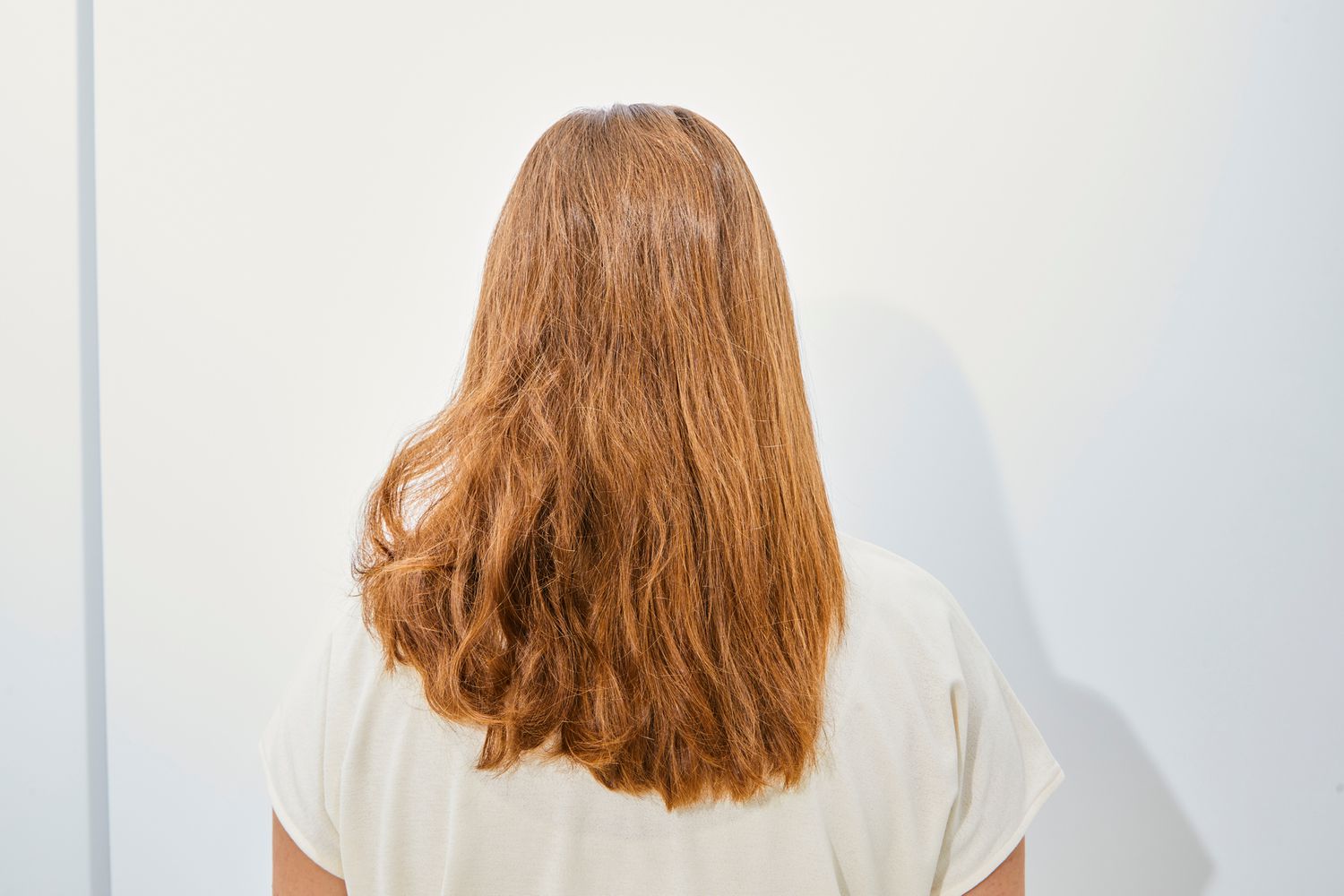 back of person's head after styling half of hair with Amika Blockade Heat Defense Serum