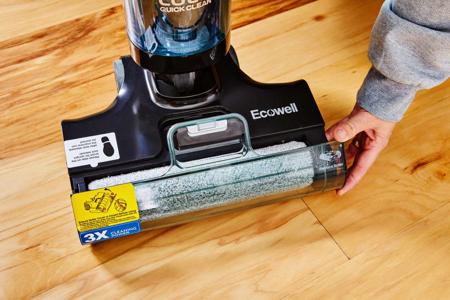 A hand lifting a glass opening to the mop pad of the Ecowell Lulu Quick Clean P05 Wet Dry Vacuum