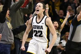 Caitlin Clark #22 of the Iowa Hawkeyes celebrates after breaking the NCAA women's all-time scoring record during the first half against the Michigan Wolverines at Carver-Hawkeye Arena on February 15, 2024 in Iowa City, Iowa. 