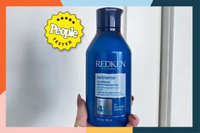 A person holding up the RedKen Extreme Length Conditioner