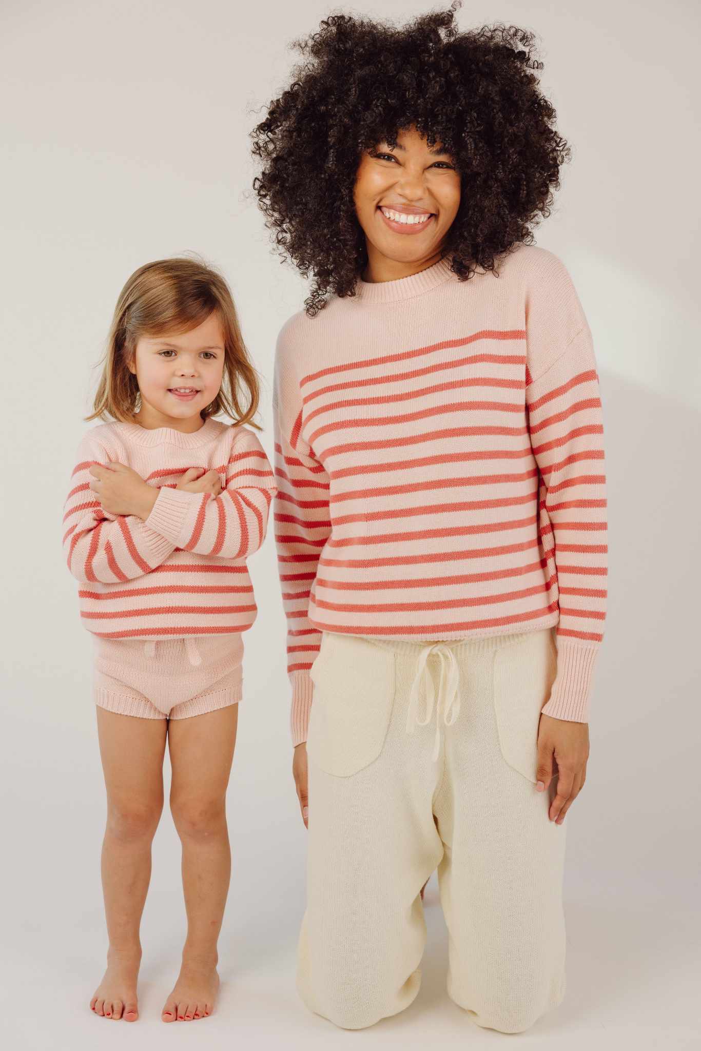 Minnow unisex pink and dusty red stripe knit sweater $75.00 https://minnowswim.com/collections/new-arrivals-for-girls/products/unisex-pink-and-dusty-red-stripe-knit-sweater