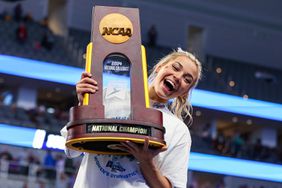  LSU's Olivia Dunne poses with the championship trophy following the 2024 NCAA Women's Gymnastics Championships at Dickies Arena in Fort Worth, TX