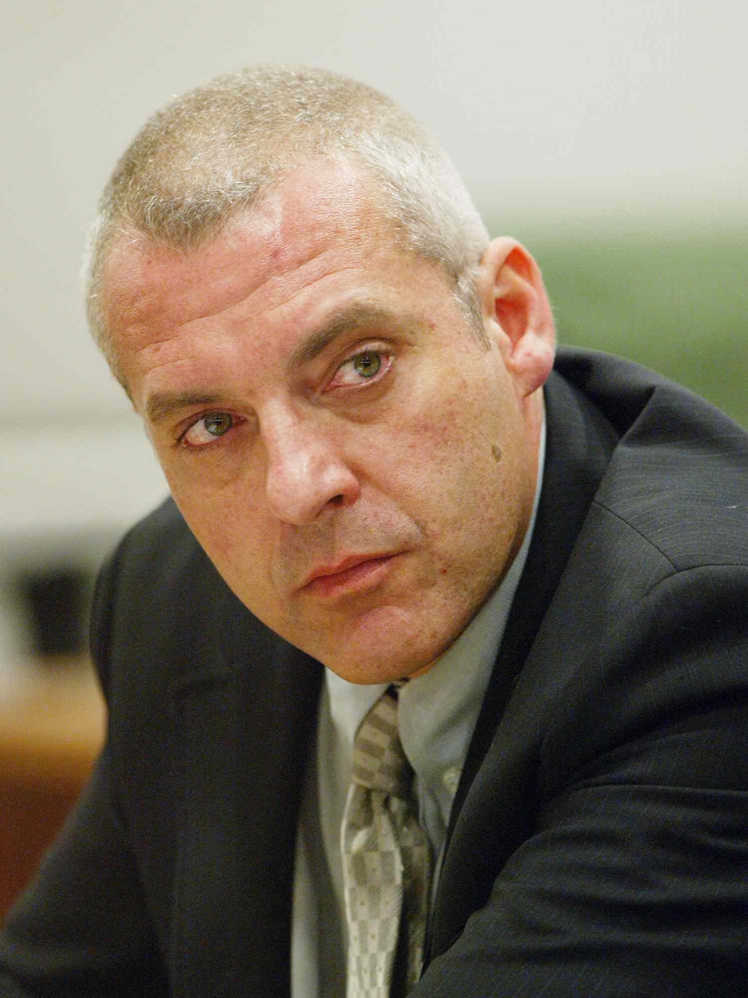 Tom Sizemore who faces 16 misdemeanor counts resulting from alleged incidents of domestic violence over the past year involing former girlfriend Heidi Fleiss listens to Fleiss' testimony at the Airport Branch Courthouse, August 6th, 2003 in Los Angeles, California