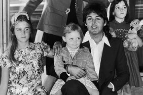 Paul McCartney poses with his wife Linda (1941 - 1998), and their daughters, left to right, Heather, Stella and Mary at an airport, 30th June 1975