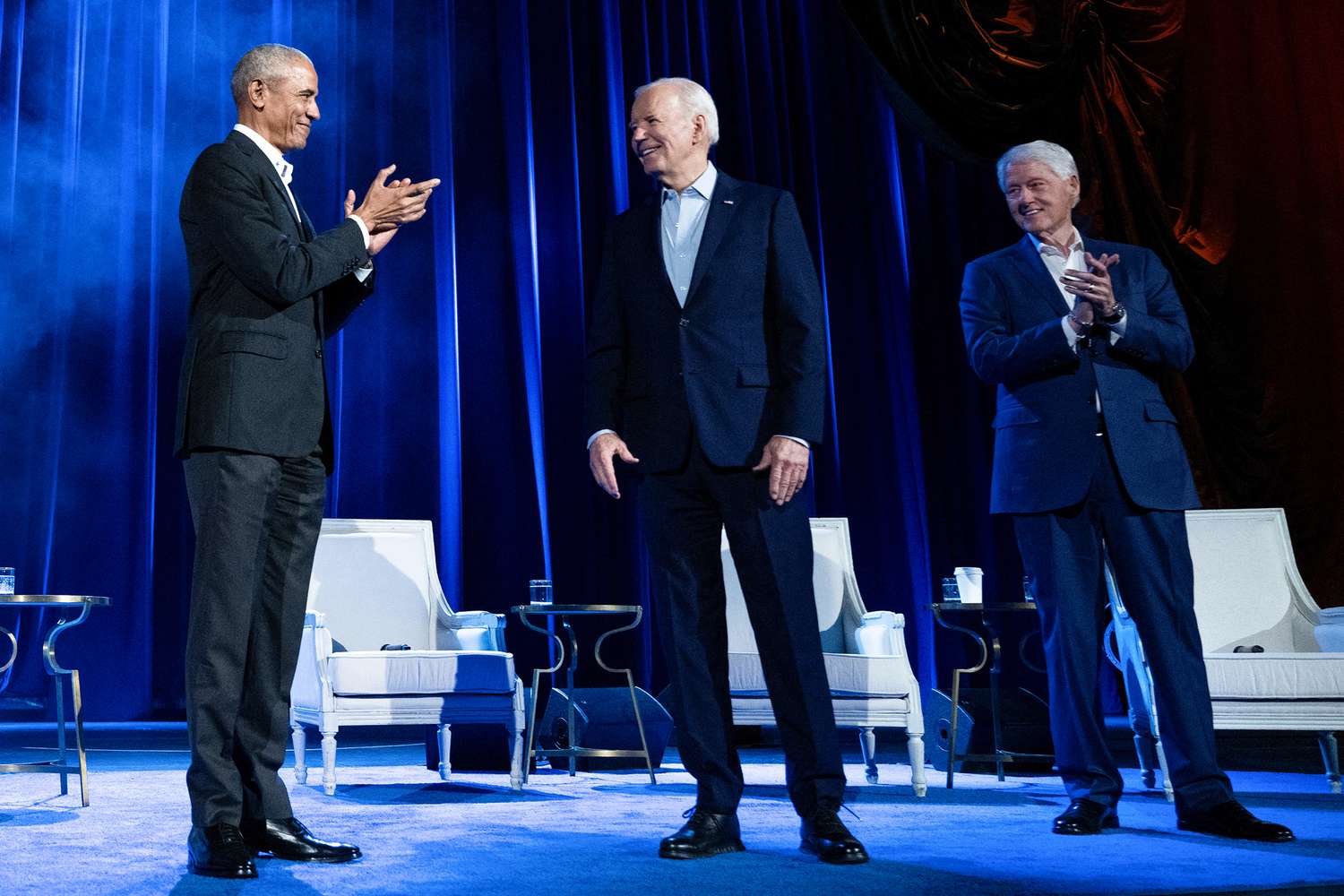 Former US President Barack Obama (L) and former US President Bill Clinton (R) clap for US President Joe Biden