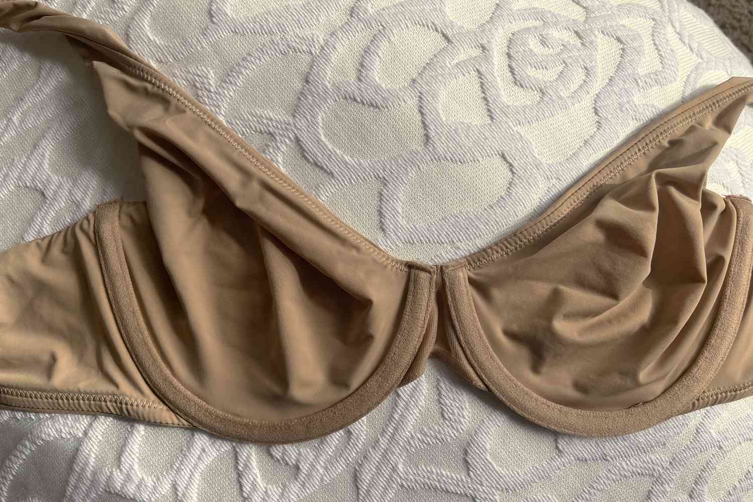 A brown colored bra on a patterned background