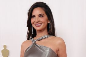 Olivia Munn Curled Hair Silver Halter Gown Hands Clasped 2024 Oscars Red Carpet