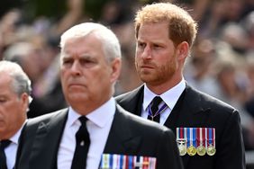 Prince Andrew, Duke of York and Prince Harry, Duke of Sussex walk behind the coffin during the procession for the Lying-in State of Queen Elizabeth II on September 14, 2022 