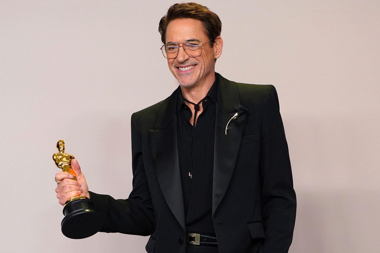 Robert Downey Jr. poses with the award for best performance by an actor in a supporting role for Oppenheimer in the press room at the Oscars on Sunday, March 10, 2024,