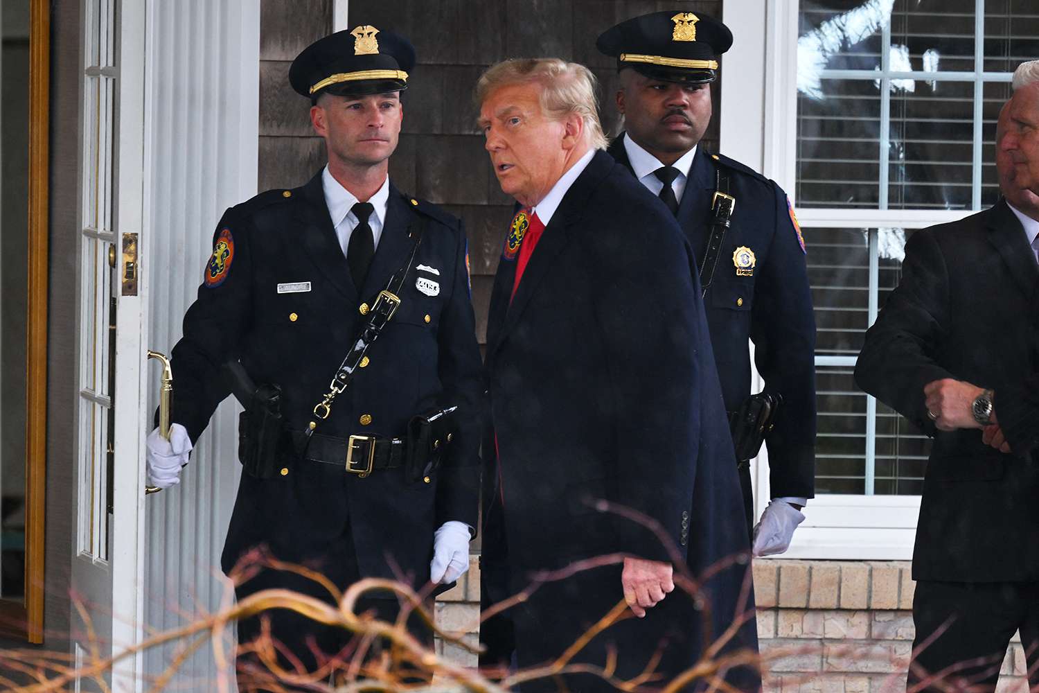 Former US President Donald Trump (C) arrives for the wake for New York Police Department (NYPD) Officer Jonathan Diller in Massapequa, Long Island, New York, on March 28, 2024. Diller was part of the NYPD's Critical Response Team when he was gunned down during a traffic stop in Queens on the night of March 25.