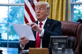 U.S. President Donald Trump reviews papers during an interview in the Oval Office of the White House in Washington, D.C