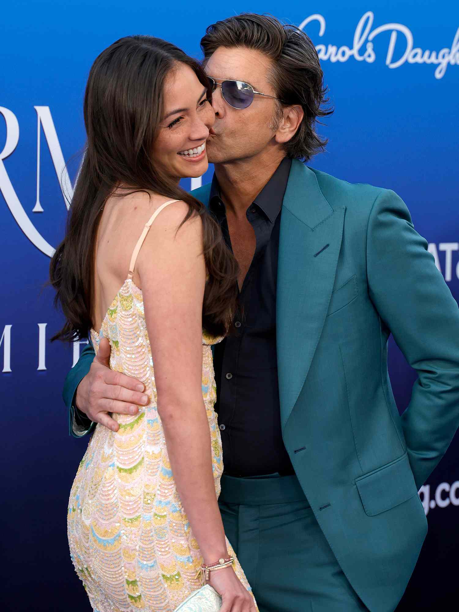 Caitlin McHugh and John Stamos attend the world premiere of Disney's "The Little Mermaid" on May 08, 2023