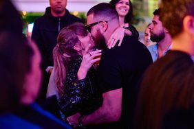 Taylor Swift and Travis Kelce Share Celebratory Kiss inside DJ Booth at XS Nightclub inside Wynn Las Vegas on Feb. 11