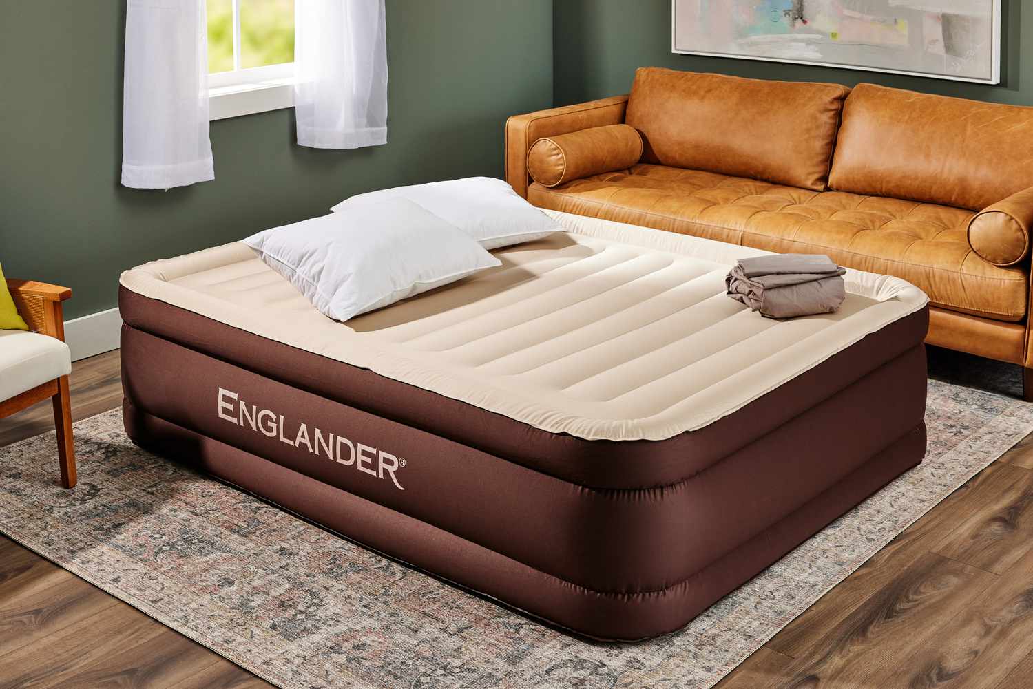 The Englander Air Mattress w/Built in Pump fully inflated near a couch
