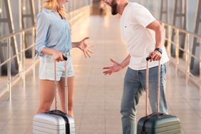 Couple arguing at airport terminal