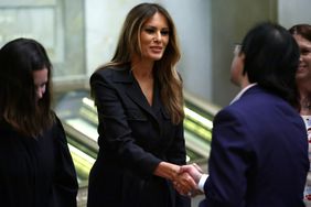 Former U.S. first lady Melania Trump shakes hands with new U.S. citizens during a naturalization ceremony at the National Archives on December 15, 2023