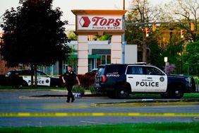 Mandatory Credit: Photo by Matt Rourke/AP/Shutterstock (12940819d) Police officer walks near the scene of a shooting at a supermarket, in Buffalo, N.Y Supermarket Shooting, Buffalo, United States - 15 May 2022