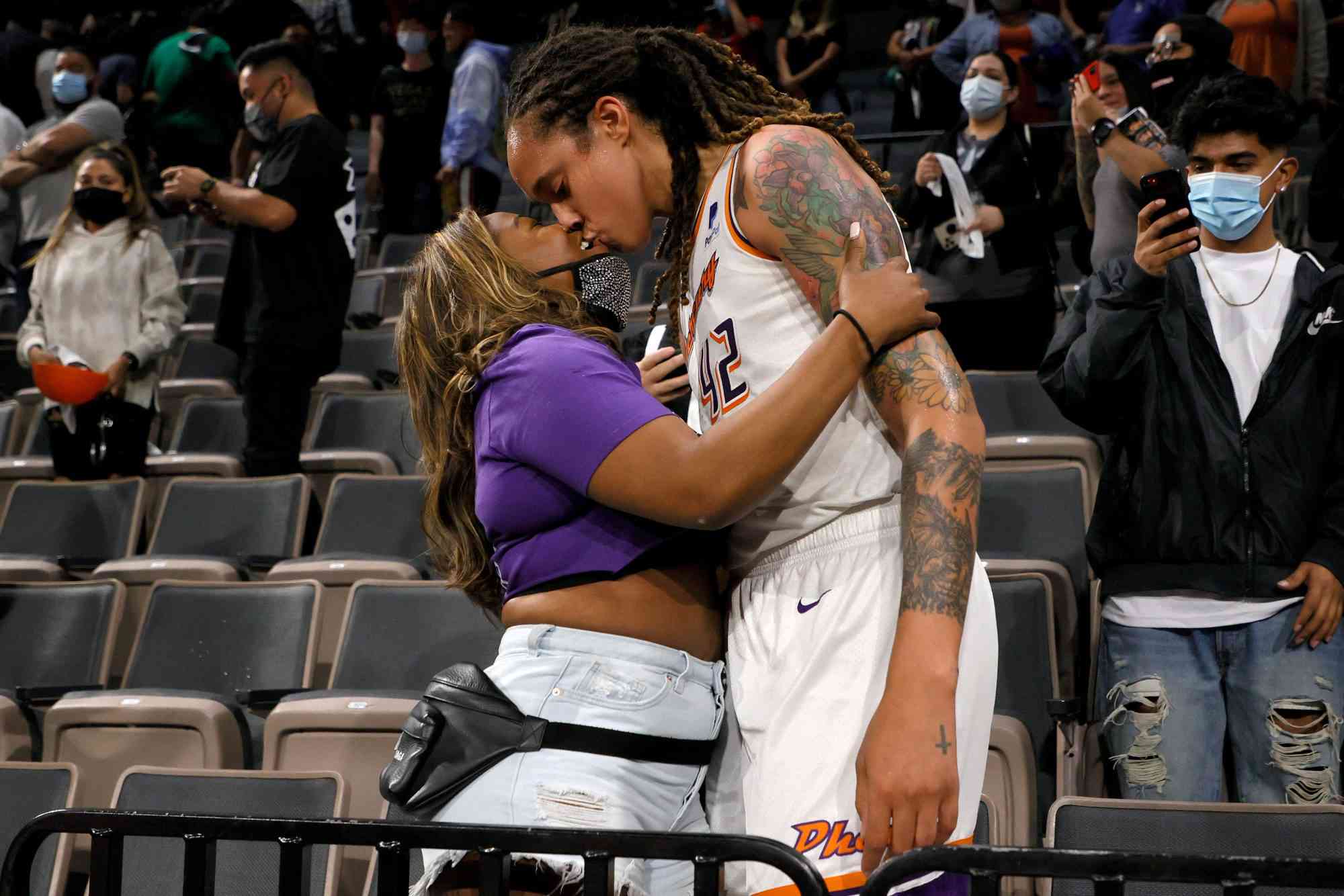 LAS VEGAS, NEVADA - OCTOBER 08: Brittney Griner #42 of the Phoenix Mercury kisses her wife Cherelle Griner in the stands after the Mercury defeated the Las Vegas Aces 87-84 in Game Five of the 2021 WNBA Playoffs semifinals to win the series at Michelob ULTRA Arena on October 8, 2021 in Las Vegas, Nevada. NOTE TO USER: User expressly acknowledges and agrees that, by downloading and or using this photograph, User is consenting to the terms and conditions of the Getty Images License Agreement. (Photo by Ethan Miller/Getty Images)