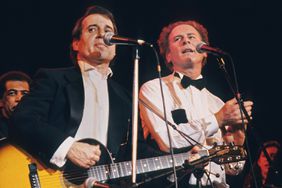 Paul Simon and Art Garfunkel of the group Simon and Garfunkel perform during the 1990 Rock and Roll Hall of Fame ceremony on January 17, 1990 at the Waldorf Astoria Hotel in New York