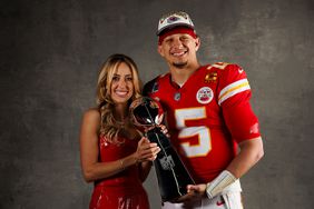 Patrick Mahomes #15 (R) of the Kansas City Chiefs and Brittany Mahomes pose for a portrait with the Vince Lombardi Trophy after Super Bowl LVIII against the San Francisco 49ers at Allegiant Stadium on February 11, 2024 in Las Vegas, Nevada. 