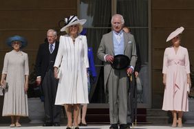 King Charles III and Queen Camilla, stand with the Duke and Duchess of Edinburgh (right) and the Duke and Duchess of Gloucester (left) as they listen to the National Anthem during a Royal Garden Party