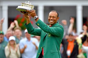 Masters champion Tiger Woods holds up the trophy during the Green Jacket Ceremony following the final round of the Masters at Augusta National Golf Club, Sunday, April 14, 2019
