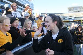 Guard Caitlin Clark #22 of the Iowa Hawkeyes interacts with fans after the match-up against the DePaul Blue Demons at Kinnick Stadium during the Crossover at Kinnick event on October 15, 2023 in Iowa City, Iowa. 
