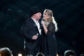 NASHVILLE, TN - NOVEMBER 02: Garth Brooks and Trisha Yearwood perform onstage at the 50th annual CMA Awards at the Bridgestone Arena on November 2, 2016 in Nashville, Tennessee. (Photo by Erika Goldring/FilmMagic)