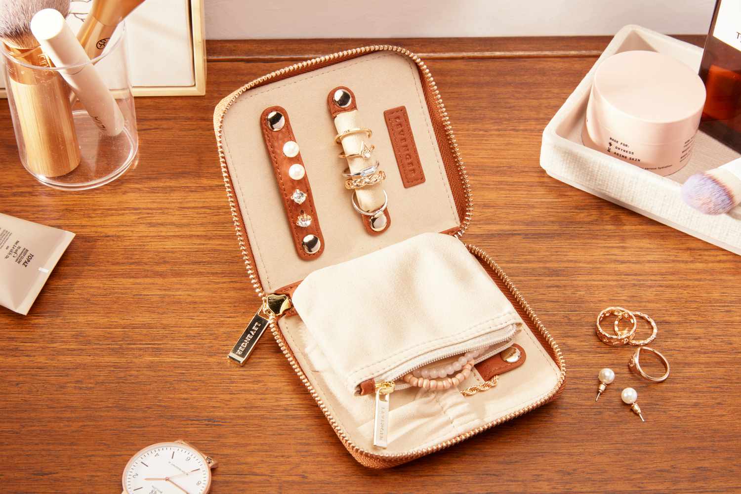 The Levenger Carrie Mini Jewelry Organizer open with jewelry inside.