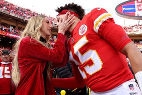 Patrick Mahomes #15 of the Kansas City Chiefs kisses his finance Brittany Matthews before the start of the AFC Championship Game against the Cincinnati Bengals at Arrowhead Stadium on January 30, 2022 in Kansas City, Missouri