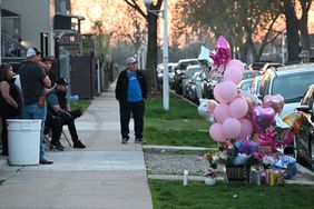 People are placing flowers, balloons, and candles at a memorial to remember the life of 9-year-old Ariana Molina, who was killed in a mass shooting that also wounded 10 others during a family celebration in the 2000 block of West 52nd Street in Chicago, Illinois, on April 14, 2024. 