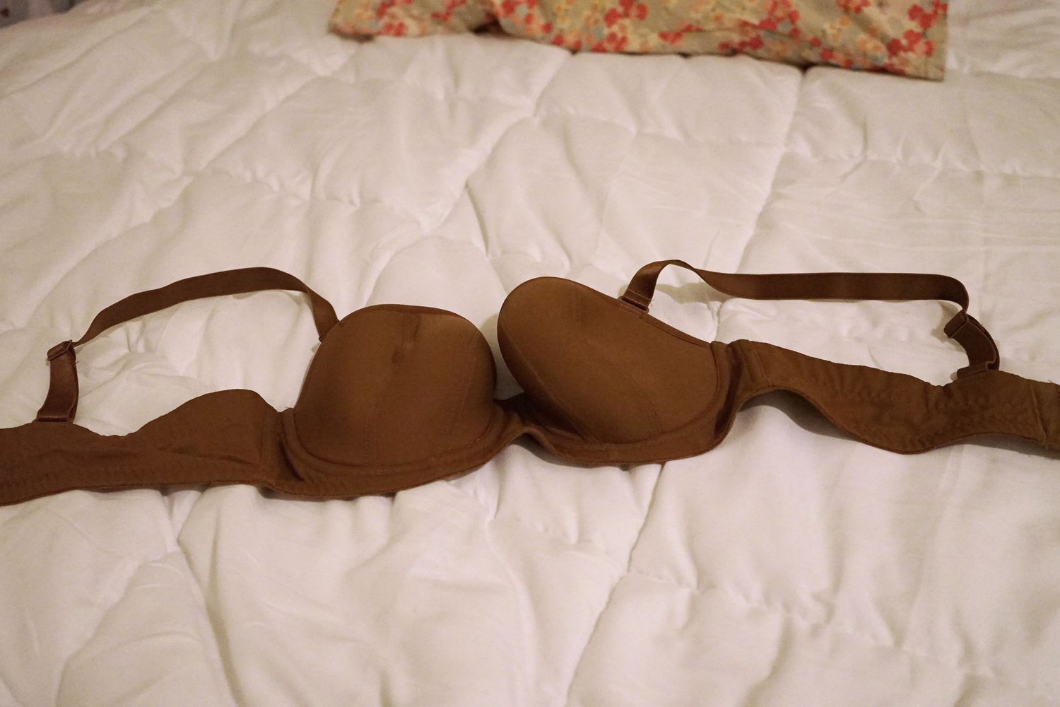 Curvy Kate Luxe Strapless Bra laying on bed with straps attached