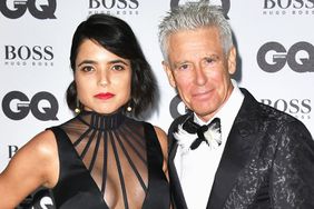 Mariana Teixeira de Carvalho and Adam Clayton arrive for GQ Men Of The Year Awards 2016 at Tate Modern on September 6, 2016 in London, England.