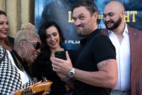 Brian Austin Green (2nd from R) shows his cast mates photos of his newborn son at the Los Angeles Premiere of "Last The Night"