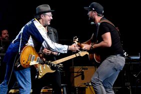 Vince Gill (L) and Luke Bryan perform durring All For The Hall at the Bridgestone Arena on April 12, 2016 in Nashville, Tennessee.