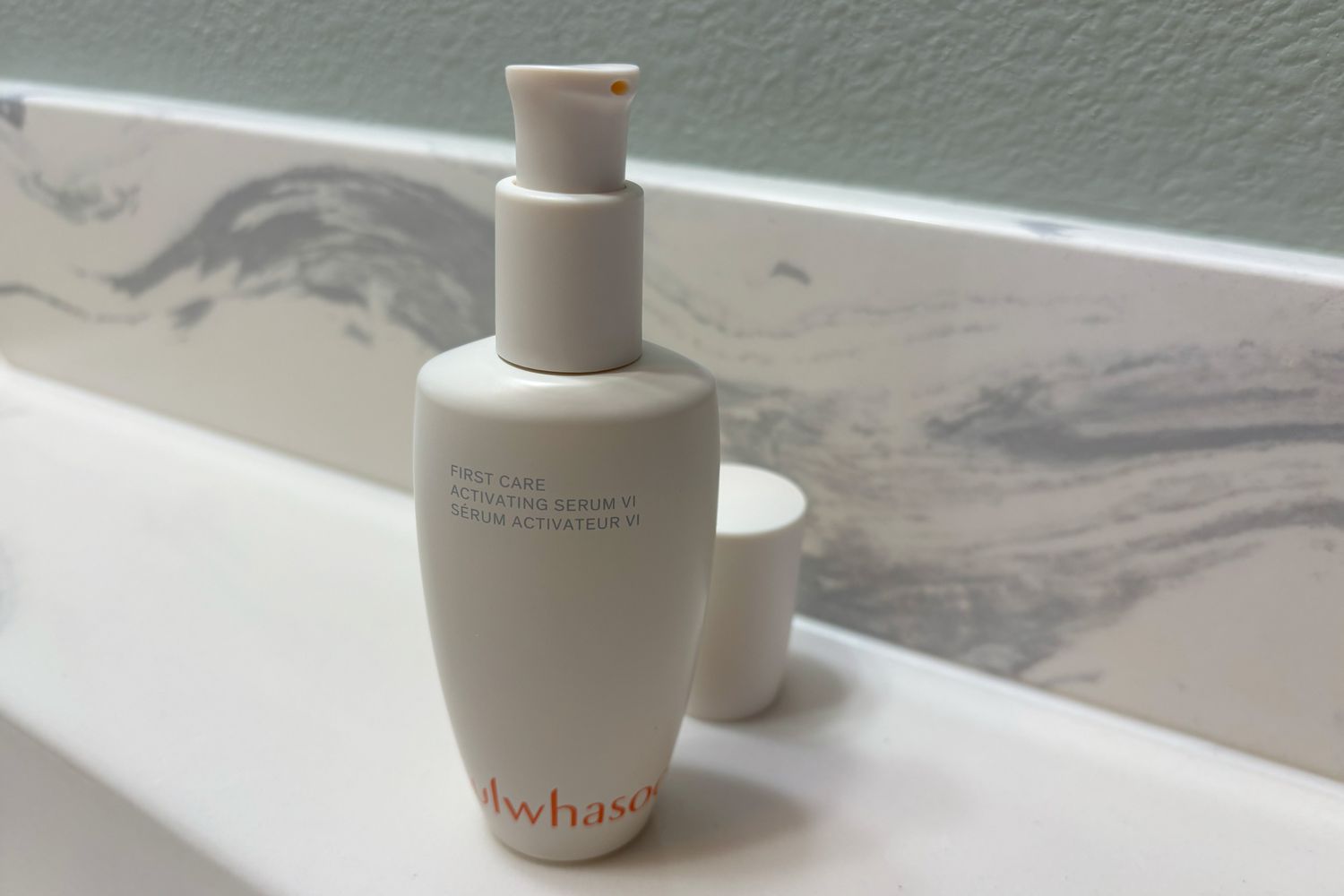 Bottle of the Sulwhasoo Anti-Aging First Care Activating Serum on countertop with top off