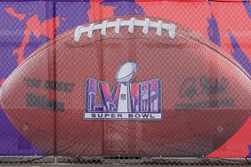 An image of a football with a Super Bowl LVIII logo covers a fence at Allegiant Stadium on February 01, 2024 in Las Vegas, Nevada. The game will be played on February 11, 2024, between the Kansas City Chiefs and the San Francisco 49ers.