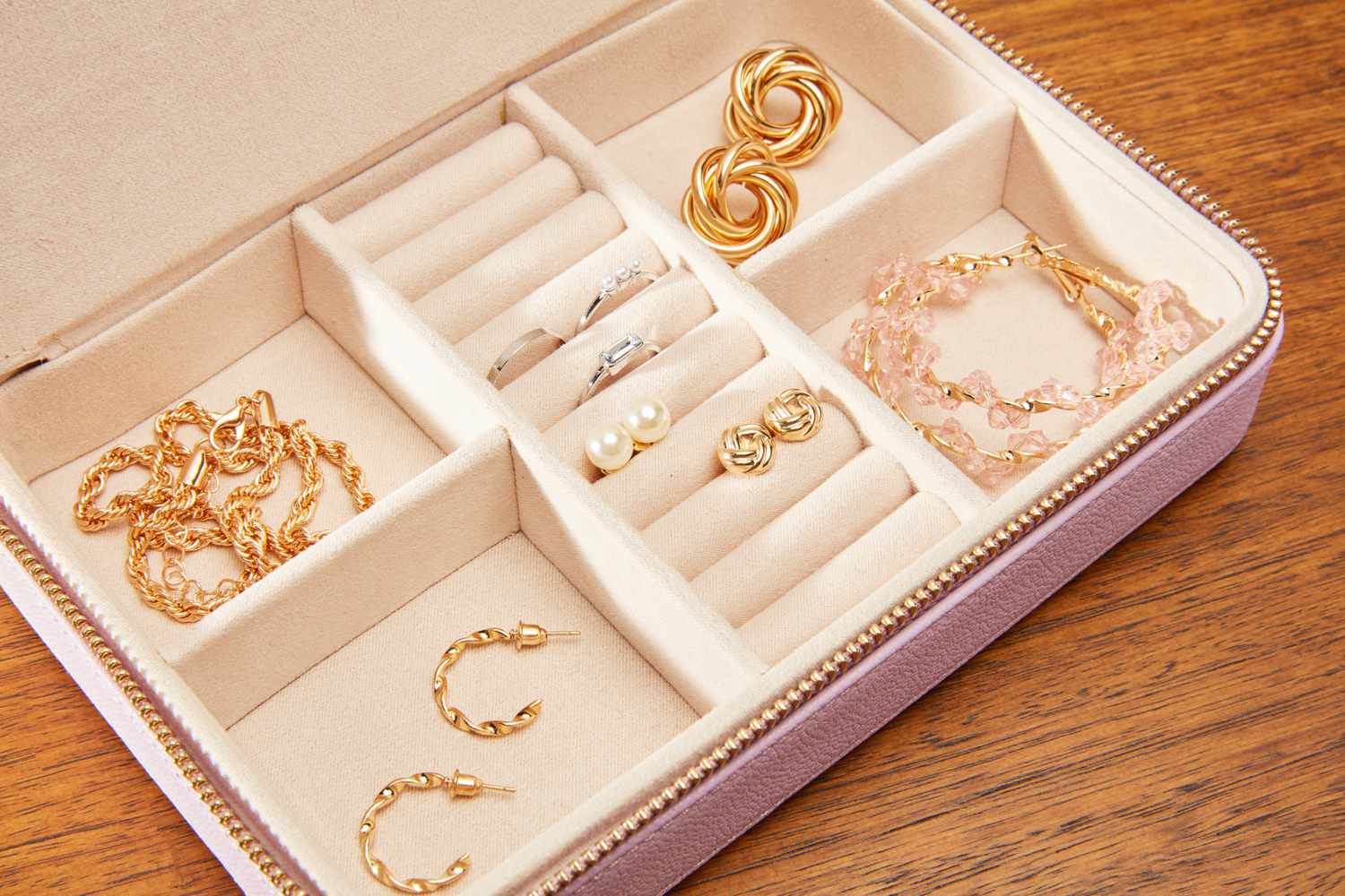 The different compartments of the Kendra Scott Medium Travel Jewelry Case filled with jewelry.