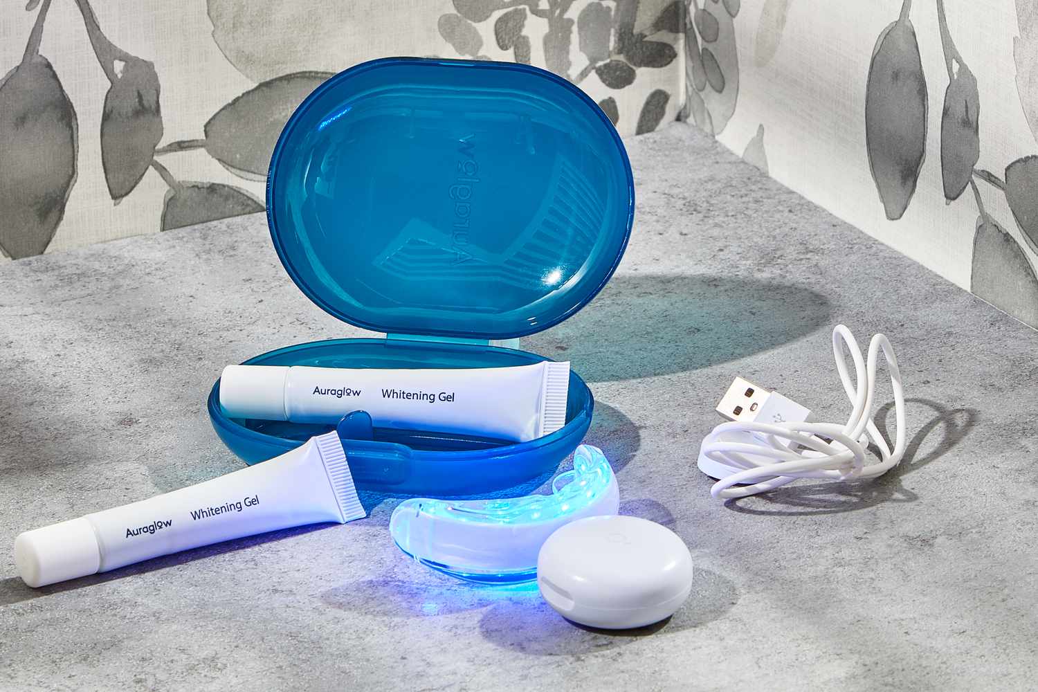 Auraglow Complete LED Whitening Kit displayed on a gray counter