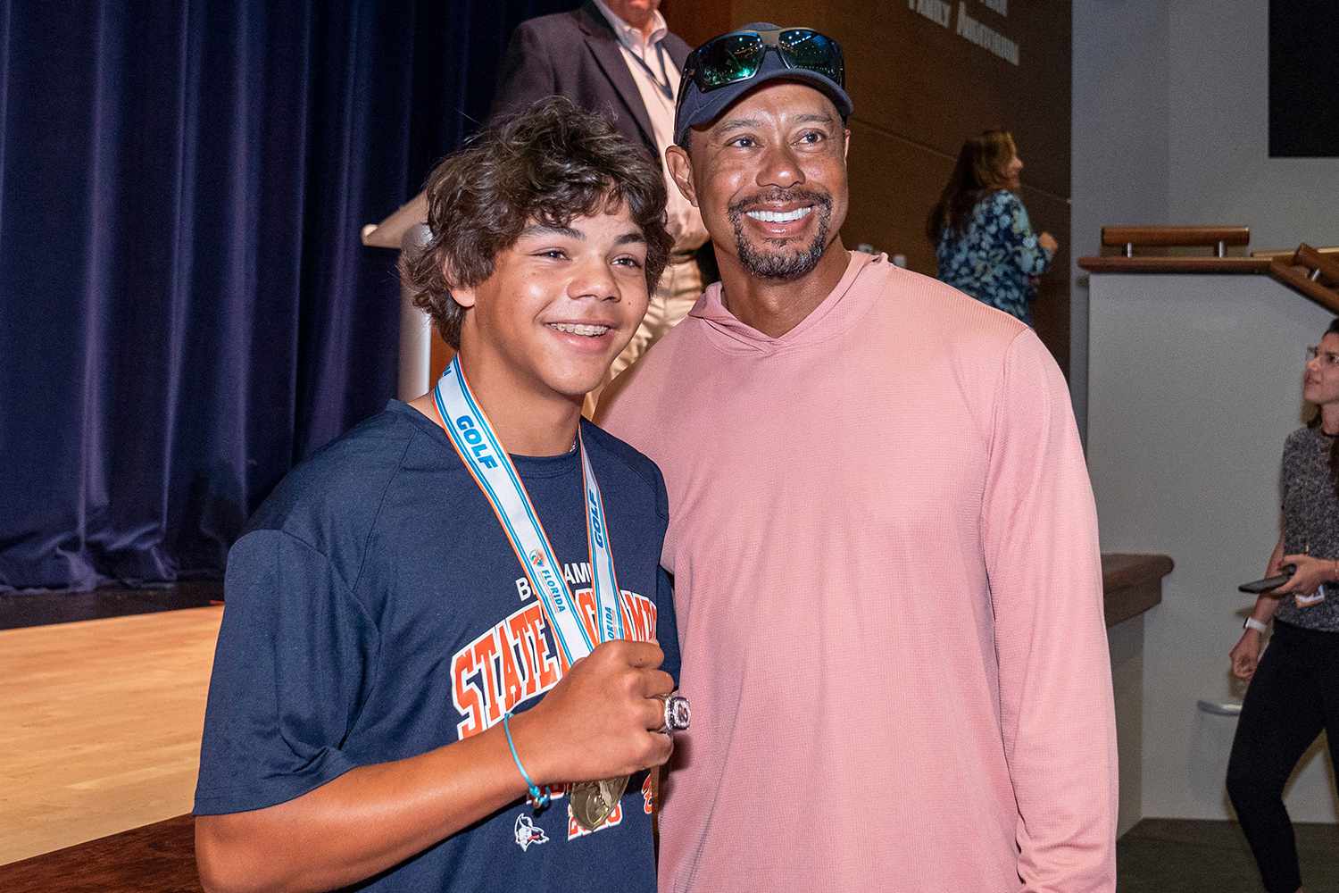 Golfer Charlie Woods shows off his new ring with his father, Tiger Woods, during a ceremony to celebrate The Benjamin School boys golf team 2023 state championship on March 26, 2024 in Palm Beach Gardens, Florida.