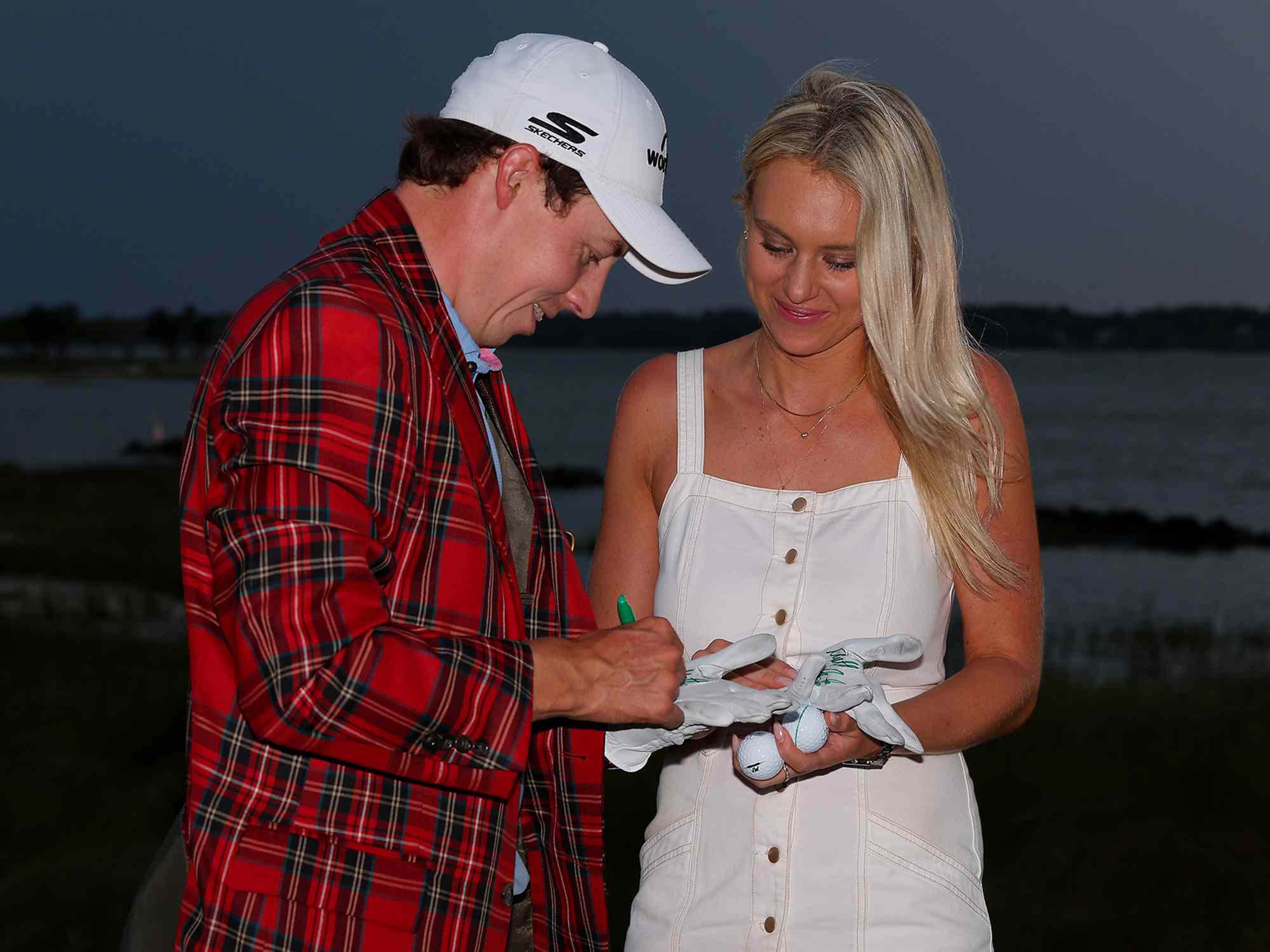 Matt Fitzpatrick of England celebrates in the Heritage Plaid tartan jacket alongside girlfriend Katherine Gaal after winning in a playoff during the final round of the RBC Heritage at Harbour Town Golf Links