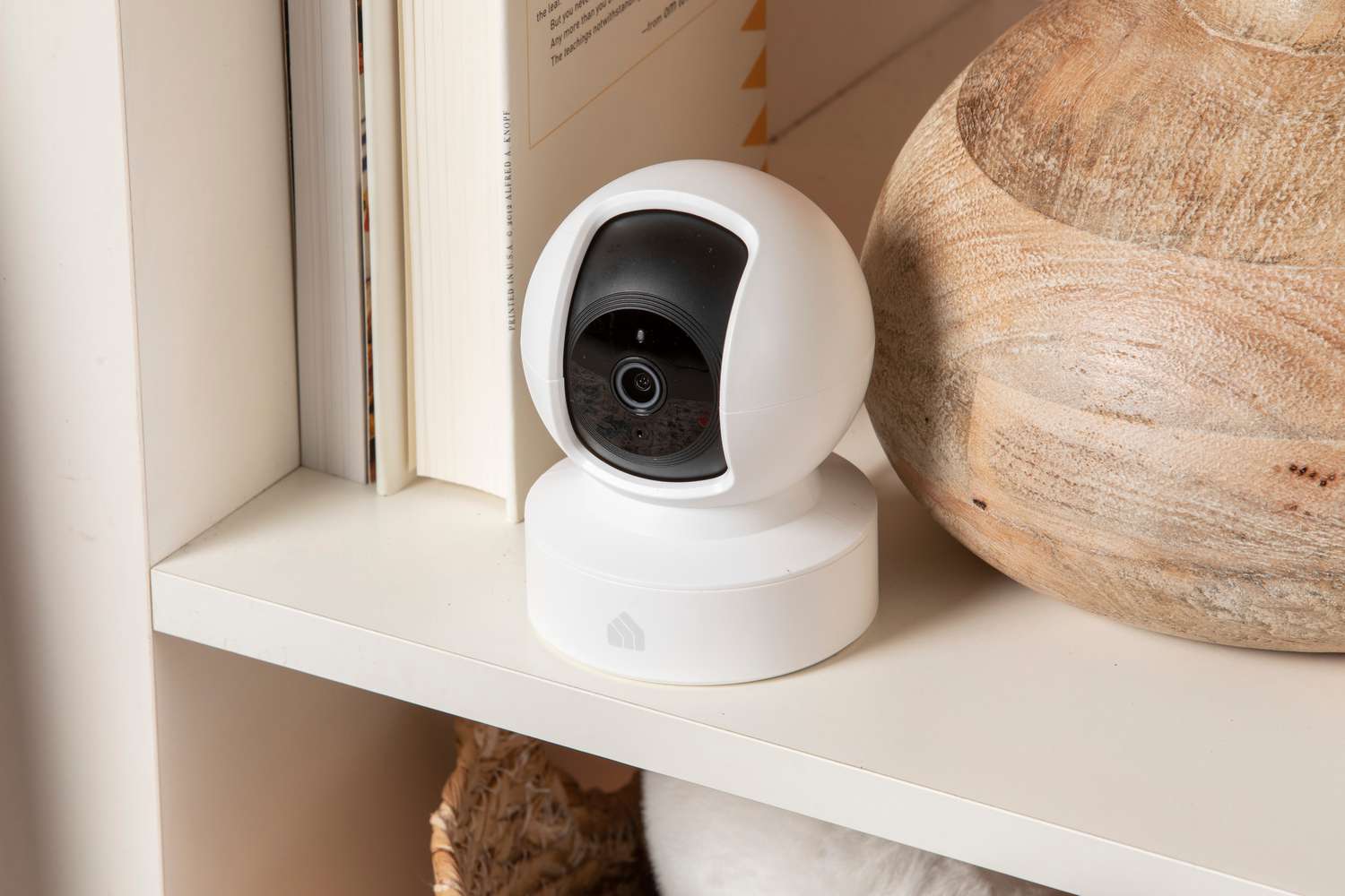 Kasa Indoor Pan/Tilt Smart Security Camera displayed on a shelf