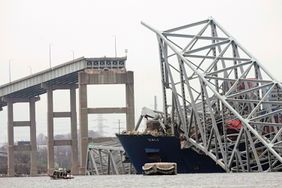 A cargo ship is stuck under the part of the structure of the Francis Scott Key Bridge after the ship hit the bridge Wednesday, March 27, 2024, in Baltimore, Md.