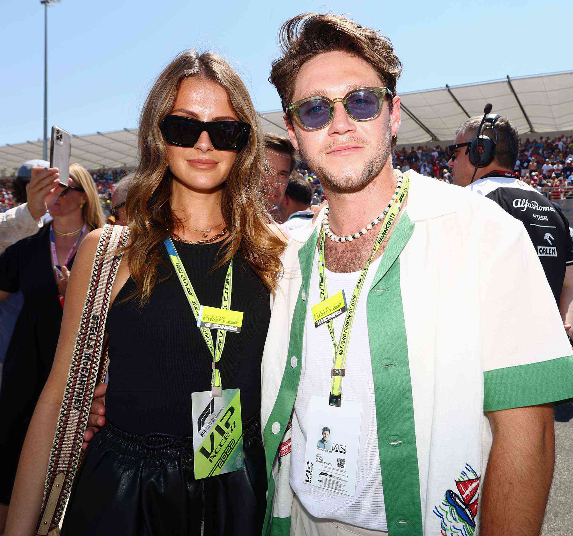 Niall Horan and Amelia Woolley pose for a photo on the grid during the F1 Grand Prix of France at Circuit Paul Ricard on July 24, 2022 in Le Castellet, France