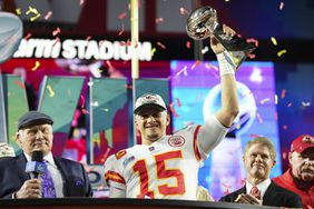Patrick Mahomes #15 of the Kansas City Chiefs hoists the Lombardi Trophy after Super Bowl LVII against the Philadelphia Eagles