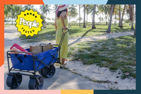 Person pulling Mac Sports Heavy Duty Collapsible Beach Wagon with nearby palm trees
