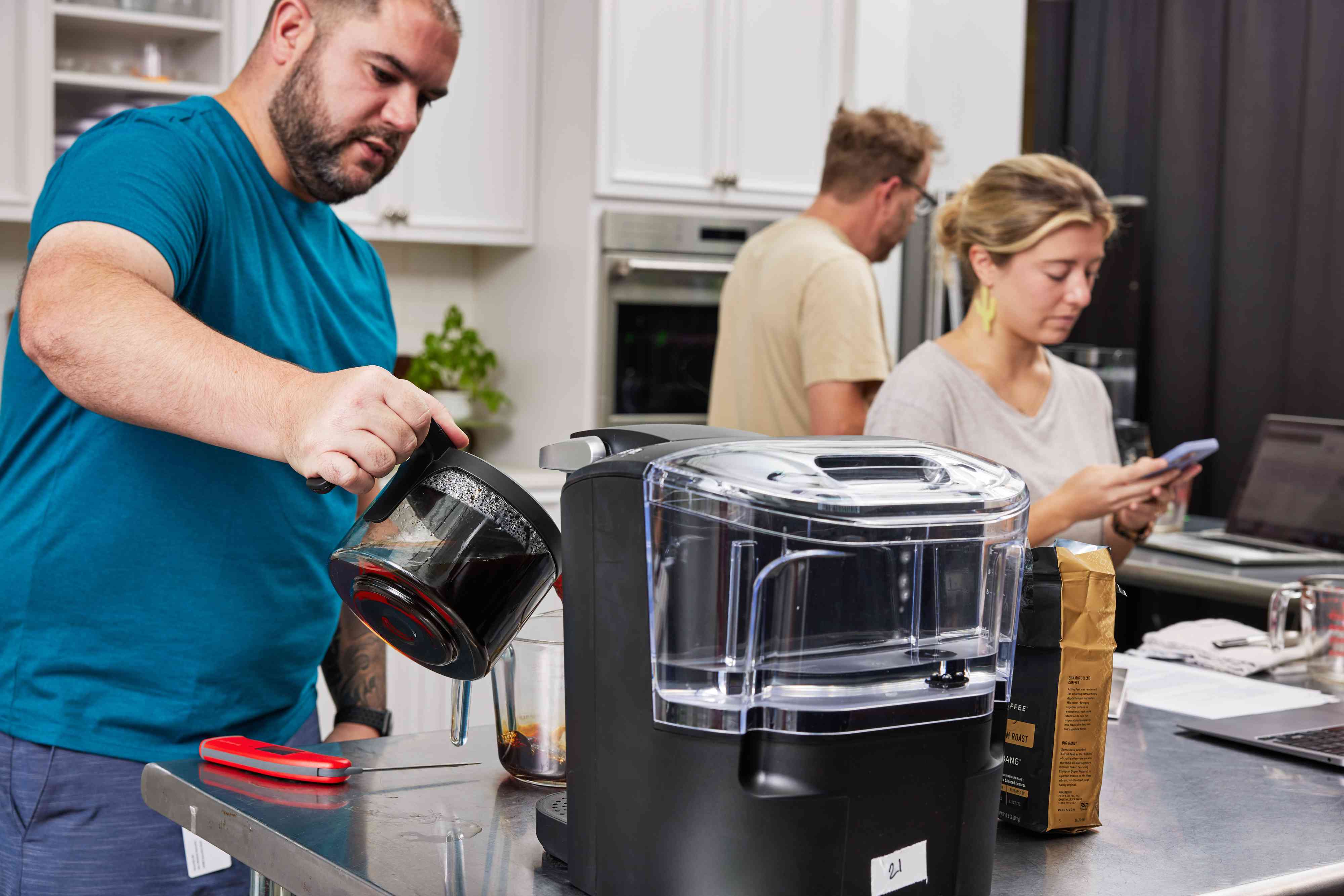 Person pouring a cup of coffee while product testing the best Keurig machines