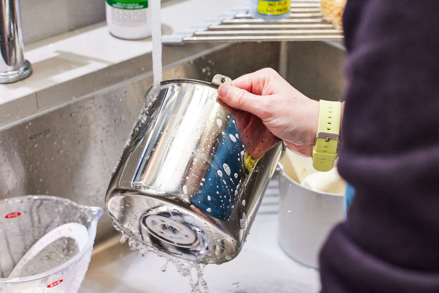 A person washing the VEVOR Ice Cream Maker's removable bucket with soap and water