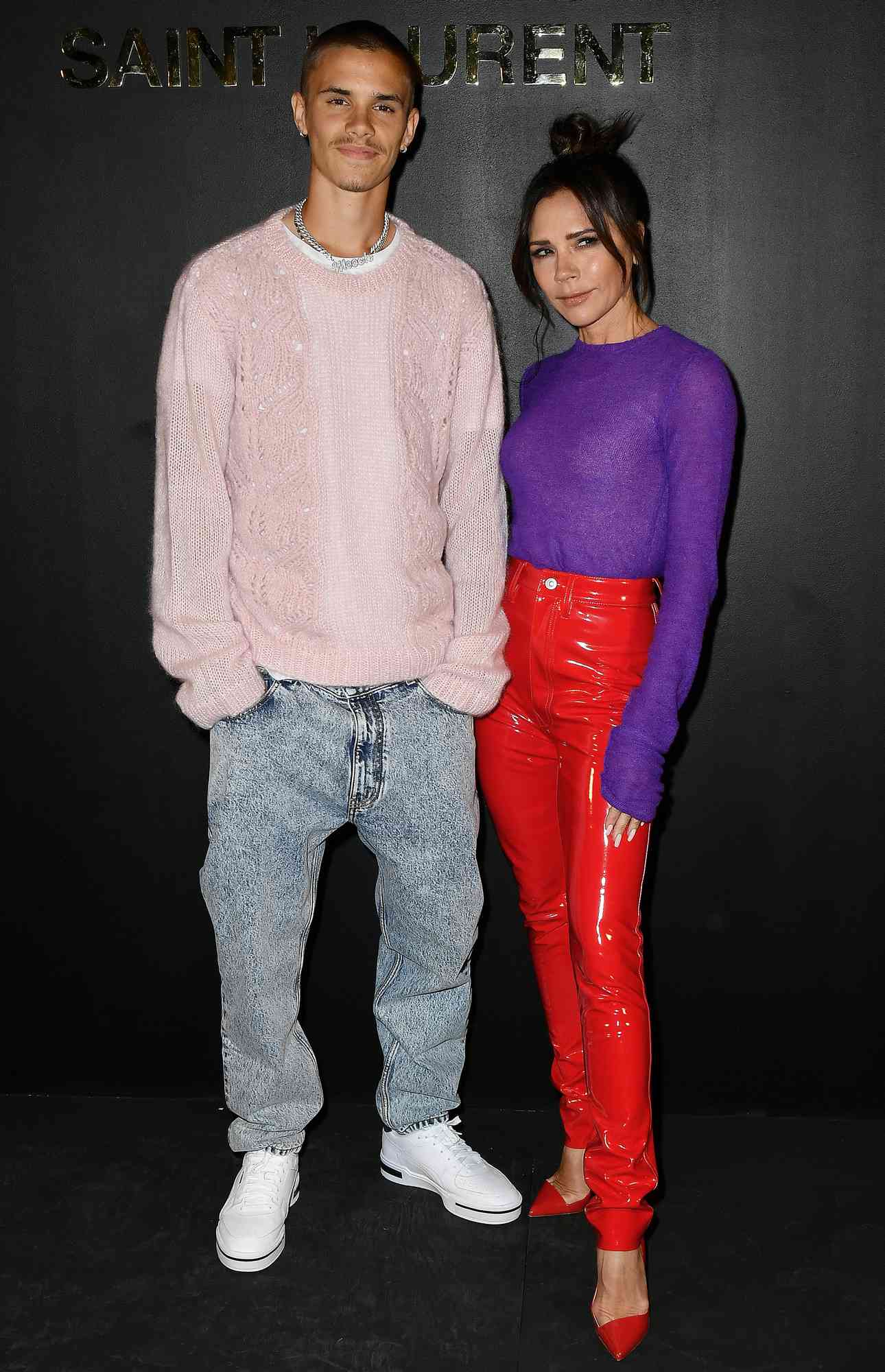 Romeo Beckham and Victoria Beckham attend the Saint-Laurent Womenswear Fall/Winter 2022/2023 show as part of Paris Fashion Week on March 01, 2022 in Paris, France